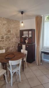 a dining room with a wooden table and chairs at Maison de ville en plein centre historique in Conflans-Sainte-Honorine +27 photos