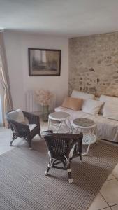 a living room with a couch and a table and chairs at Maison de ville en plein centre historique in Conflans-Sainte-Honorine