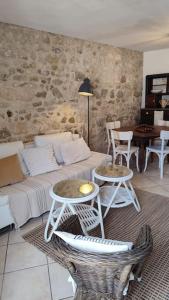 a living room with a couch and two tables at Maison de ville en plein centre historique in Conflans-Sainte-Honorine
