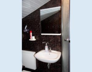 a bathroom with a sink and a mirror at Coffee Apartments in Jūrmala +33 photos