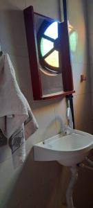 a bathroom with a sink and a mirror and a towel at Casa bela flor in Nova Friburgo +15 photos