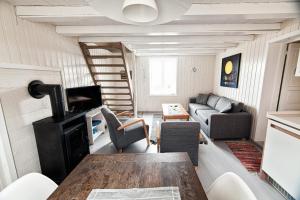 een woonkamer met een tafel en een bank bij Rorbu burekka, Stamsund in Stamsund