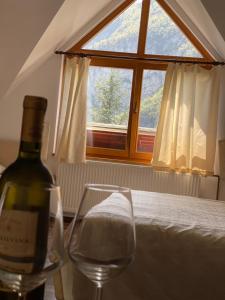 a bottle of wine sitting next to a wine glass at Restoran Motel Kanjon in Skender Vakuf