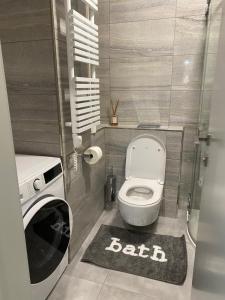a small bathroom with a toilet and a rug at Modern Living in Budapest 2 in Budapest +26 photos