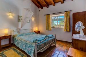 a bedroom with a bed and a window at Quinta Velha Authentic Farmhouse Experience by LovelyStay in Senhora do Verde +54 photos