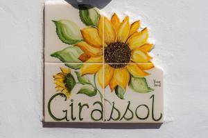 a sign on a wall with a sunflower on it at Quinta Velha Authentic Farmhouse Experience by LovelyStay in Senhora do Verde