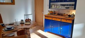 a kitchen with blue cabinets and a wooden table at 21KR Bed and Breakfast, close to beach, town centre and golf in St. Andrews