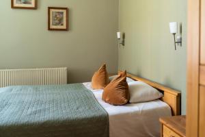 a bedroom with a bed and two pillows on it at Apartamenti Kurshi in Jūrmala