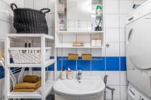 a bathroom with a sink and a washing machine at Beautiful apartment in the heart of Oslo! in Oslo
