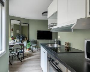 a kitchen with a counter and a dining room at Beautiful apartment in the heart of Oslo! in Oslo +9 photos