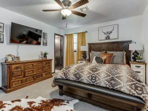 a bedroom with a bed and a ceiling fan at Country home near Norman on 5 ac in Newcastle