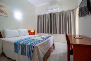 Postel nebo postele na pokoji v ubytování Hotel Dan Inn Barretos by Nacional Inn