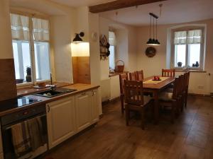 a kitchen and dining room with a table and chairs at HabaChalupa in Šumperk +36 photos