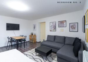 a living room with a couch and a table at The Bookhouse, 5-bedroom residence by Prague Castle in Prague +15 photos