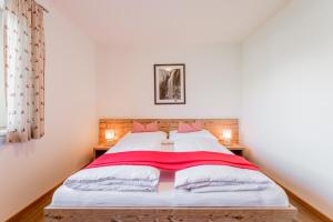 シュトゥンムにあるFerienwohnungen Barbaraのベッドルーム1室(赤い毛布付きのベッド1台付)