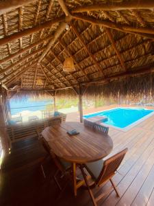 a patio with a table and chairs and a swimming pool at Vue imprenable sur la mer des Caraïbes in Les Anses-dʼArlets +20 photos