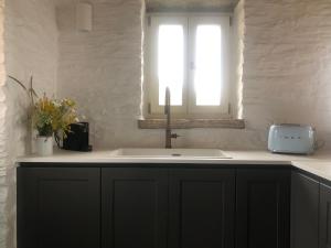 a kitchen with a sink and a window at ARIA Kea Sunset Homes in Milopótamos +61 photos