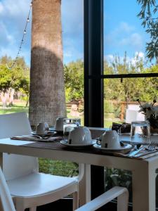 a table with plates and utensils on top of a table with a lighthouse at Torre Galli-Dimora di Campagna in Gasponi