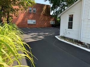 a parking lot next to a brick building at Downtown Willoughby Historic District Gem #2 in Willoughby