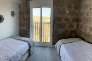 Ένα ή περισσότερα κρεβάτια σε δωμάτιο στο El Alpendre