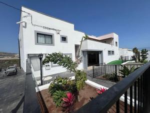 a white house with a balcony with a fence at El Alpendre in Moya