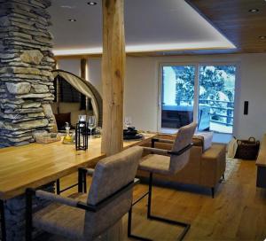 a living room with a wooden table and chairs at Cozy Forest Wellness Suite in Saint-Vith