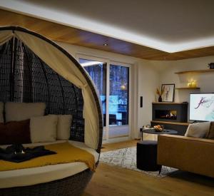 a living room with a couch and a window at Cozy Forest Wellness Suite in Saint-Vith