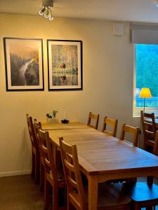 a dining room with a wooden table and chairs at STF Sälen Torgåsgården in Lima +114 photos