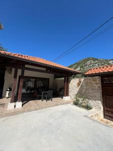 a patio of a house with a table and a chair at Kamena Idila in Stolac
