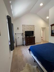 a bedroom with a bed and a flat screen tv at Kamena Idila in Stolac