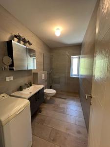 a bathroom with a sink and a toilet in it at Kamena Idila in Stolac +50 photos