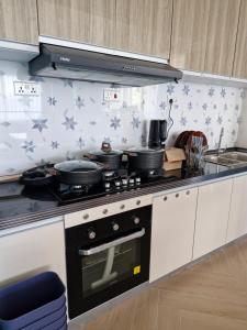 a kitchen with a stove top oven with stars on the wall at Laurel Haven Abode in Nairobi