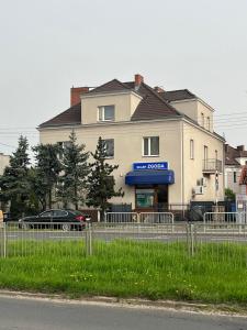 a building with a fence in front of it at Apartament 01 in Poznań