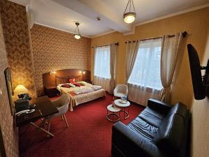 a hotel room with a bed and a couch at Hotel Galicja SPA Wieliczka in Wieliczka +170 photos