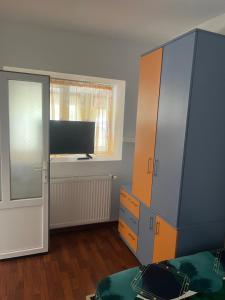 a bedroom with a bed and a dresser and a window at Casa Clara in Techirghiol