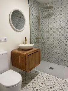 a bathroom with a sink and a toilet at Casa Rural El Rincón de Beatriz in Ayódar +32 photos