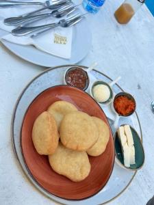 a plate of food with biscuits on a table at Apartman Njegoš Lux Titova vila in Palisad