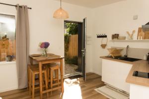 a kitchen with a small table and a counter top at Le Cabanon Malouin in Saint Malo