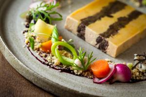 a plate of food with vegetables and cheese on it at Prestige Hotel Budapest in Budapest