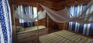 Postel nebo postele na pokoji v ubytování DHATITO BEACH - Sè