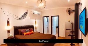 a bedroom with a large bed in a room at La Plume in Ban Phe