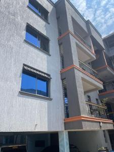 a building with two balconies on the side of it at Cozy Residence III 2bedroom Apartment near Speke Resort in Kampala