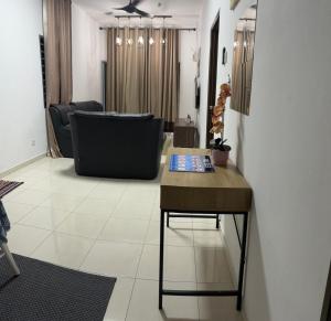 a living room with a table and a couch at LaRinDa Teluk Kemang Private Pool - Islamic in Port Dickson
