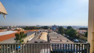 a view of a city from the balcony of a building at RXS Hostel in Colina