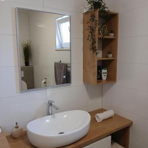 a bathroom with a white sink and a mirror at The Father's House in Bol +39 photos