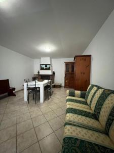 a living room with a couch and a table at CentoMetri Open in San Massimo +2 photos