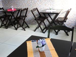 a table with two chairs and a table with two tables at Mariba's Pousada in João Pessoa