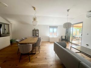 a living room with a dining room table and chairs at NINOA holidays in Petrcane