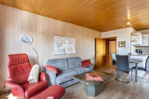 a living room with a couch and a table at Haus Schönblick in Willingen