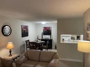 a living room with a couch and a table at Chris Cozy Condo CW #107 Edmonton in Edmonton